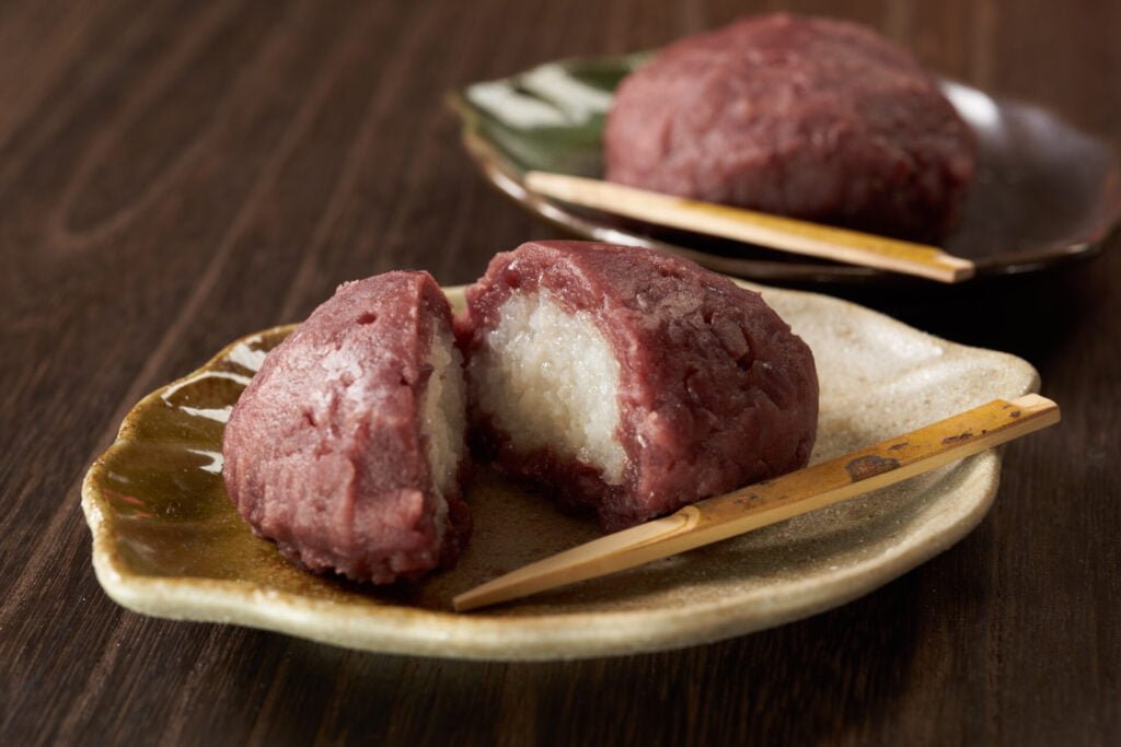 Botamochi is a wagashi (Japanese confection) made with glutinous rice, white rice, and sweet azuki paste (red bean paste).
